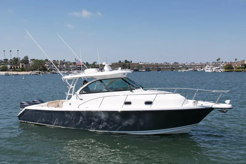 Hobi One Yacht Photos Pics 2015 Pursuit 345 Offshore boat on calm water, clear sky, coastal background.