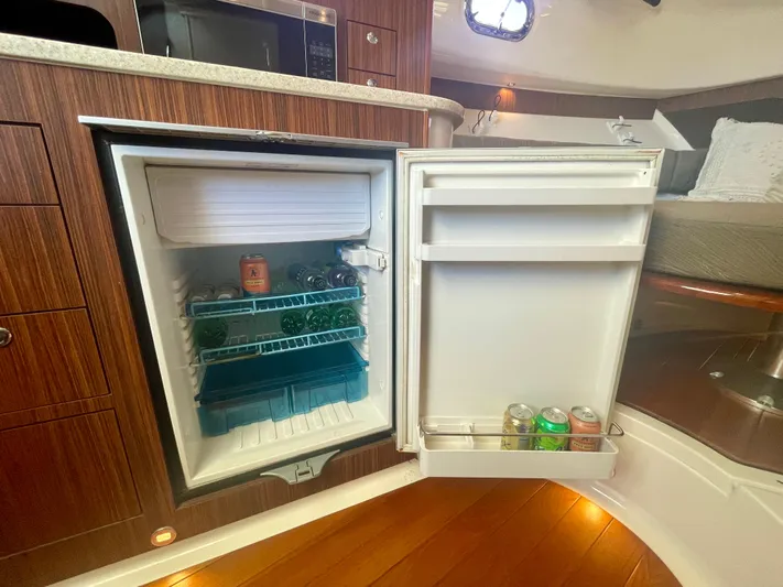 Hobi One Yacht Photos Pics Open fridge in 2015 Pursuit 345 Offshore boat interior, stocked with drinks.