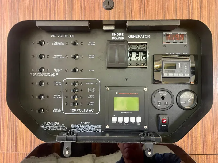 Hobi One Yacht Photos Pics Electrical control panel of a 2015 Pursuit 345 Offshore boat, featuring shore power and generator switches.