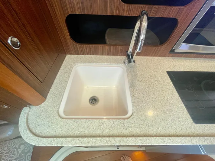 Hobi One Yacht Photos Pics 2015 Pursuit 345 Offshore kitchen sink with modern faucet and countertop.