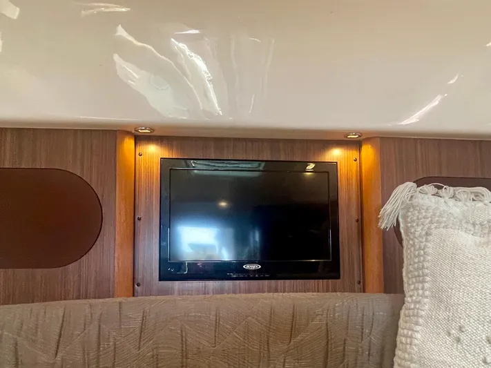 Hobi One Yacht Photos Pics Interior of 2015 Pursuit 345 Offshore boat with mounted TV and cozy seating.