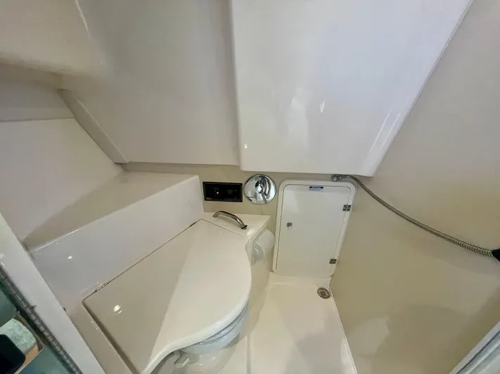 Hobi One Yacht Photos Pics 2015 Pursuit 345 Offshore boat bathroom with toilet and shower area.