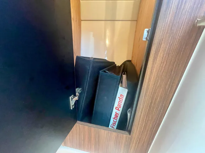 Hobi One Yacht Photos Pics Open cabinet on 2015 Pursuit 345 Offshore boat with Fischer Panda manual inside.