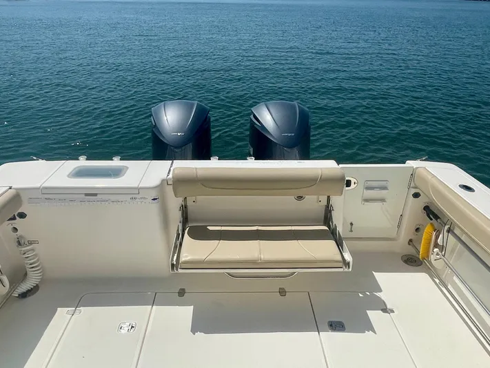 Hobi One Yacht Photos Pics 2015 Pursuit 345 Offshore boat with dual engines and seating, on calm water.