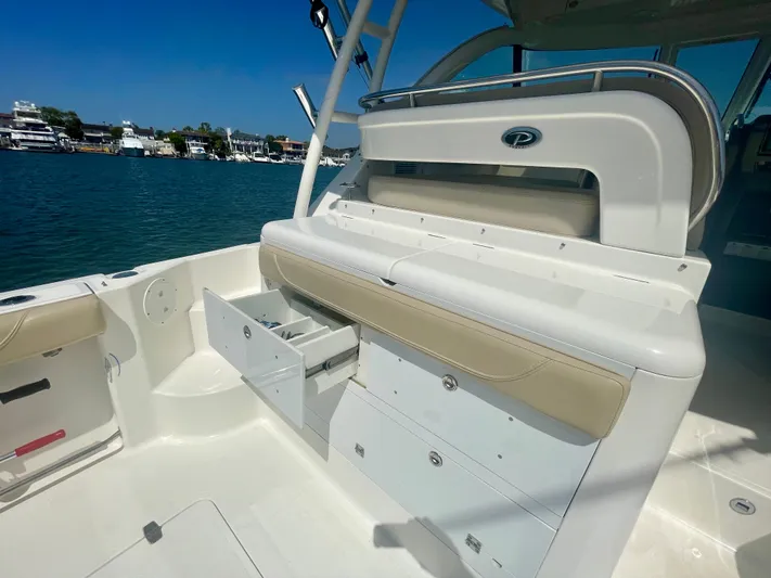 Hobi One Yacht Photos Pics 2015 Pursuit 345 Offshore boat interior with storage drawers, docked by the water.