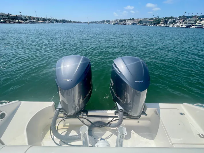 Hobi One Yacht Photos Pics 2015 Pursuit 345 Offshore boat with dual outboard engines on a sunny day.