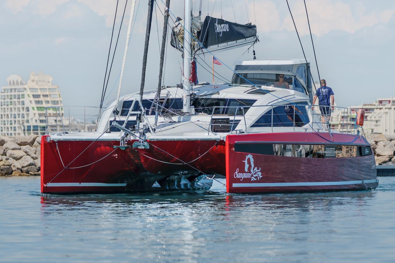 Red Privilege Signature 510 catamaran in harbor, year 2025.