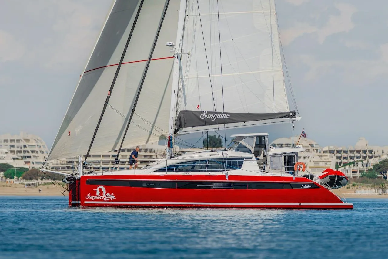 Red Privilege Signature 510 yacht sailing on calm waters, year 2025.