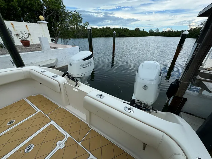  Yacht Photos Pics Boat docked by serene water, featuring Mamba 350 model, 2009, with Suzuki engines.