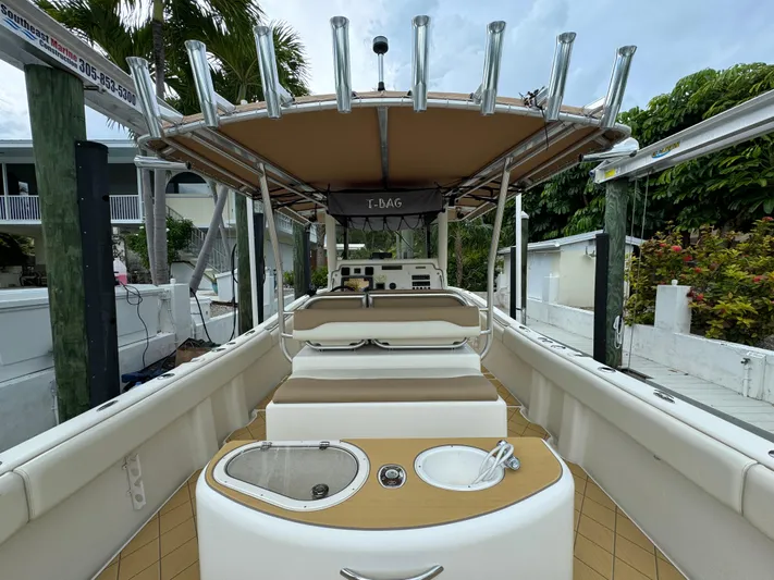  Yacht Photos Pics 2009 Mamba 350 boat interior with seating and helm, docked near lush greenery.