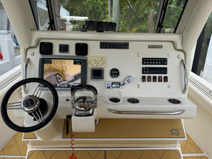  Yacht Photos Pics Control panel of a 2009 Mamba 350 boat with navigation equipment and steering wheel.