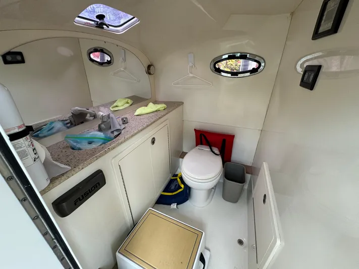  Yacht Photos Pics Boat bathroom interior with sink, toilet, and storage in a 2009 Mamba 350 model.