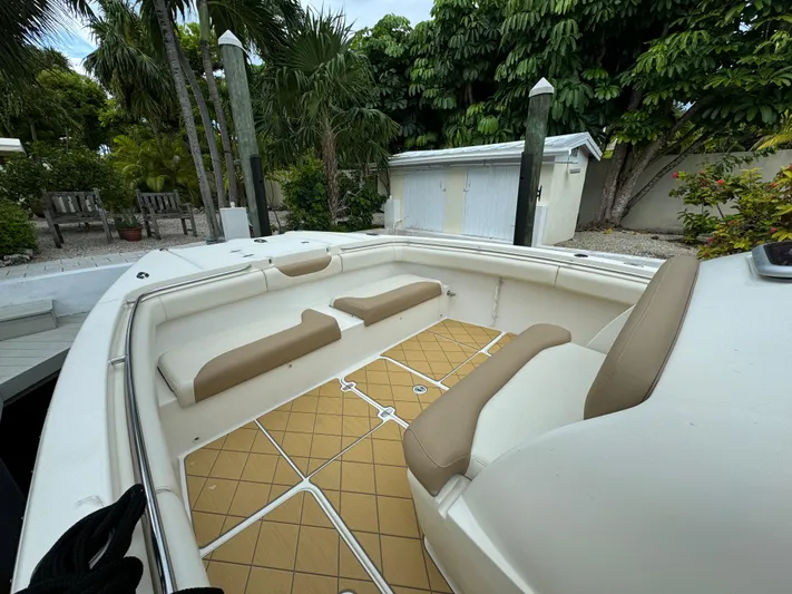  Yacht Photos Pics 2009 Mamba 350 boat interior with beige seating and tan flooring, surrounded by lush greenery.