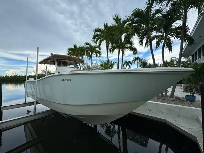  Yacht Photos Pics 2009 Mamba 350 boat docked near palm trees and water.