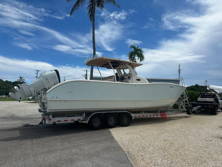  Yacht Photos Pics 2009 Mamba 350 boat on trailer, parked outdoors under a clear blue sky.