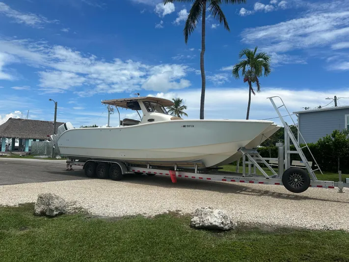  Yacht Photos Pics 2009 Mamba 350 boat on trailer, parked outdoors under a clear blue sky.