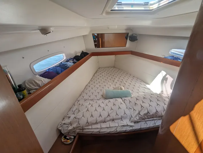 La Gaspesienne Yacht Photos Pics Cozy cabin interior of 2011 Beneteau Oceanis 40 sailboat with bed and porthole windows.