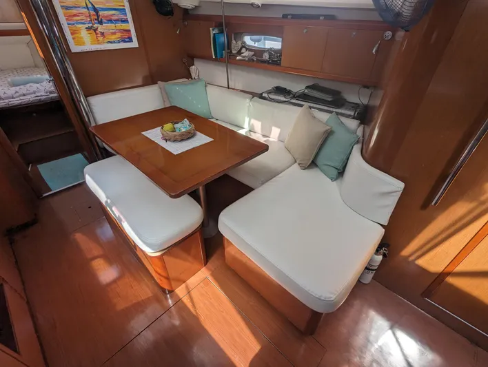 La Gaspesienne Yacht Photos Pics Interior of 2011 Beneteau Oceanis 40 sailboat with cozy seating and wooden table.