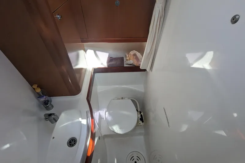 La Gaspesienne Yacht Photos Pics Bathroom interior of 2011 Beneteau Oceanis 40 yacht, featuring sink and toilet.