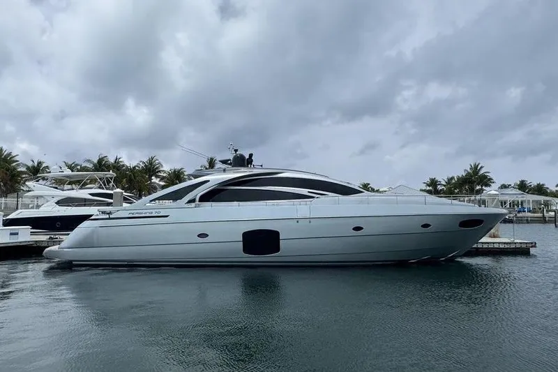  Yacht Photos Pics 2015 Pershing 70 yacht docked in a marina under cloudy skies.
