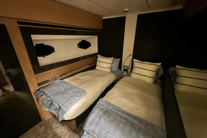  Yacht Photos Pics Interior of 2015 Pershing 70 yacht with twin beds and modern decor.