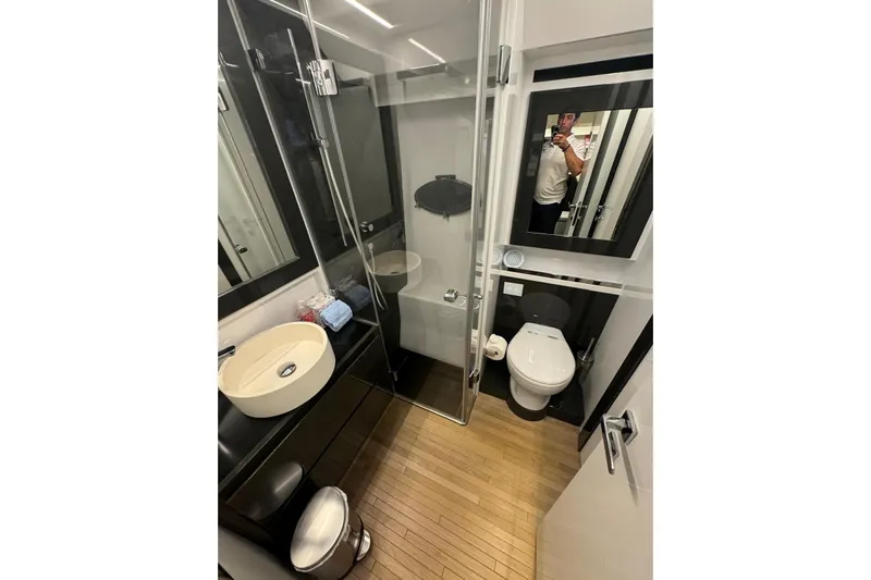  Yacht Photos Pics Luxurious bathroom in 2015 Pershing 70 yacht with modern fixtures and wooden flooring.