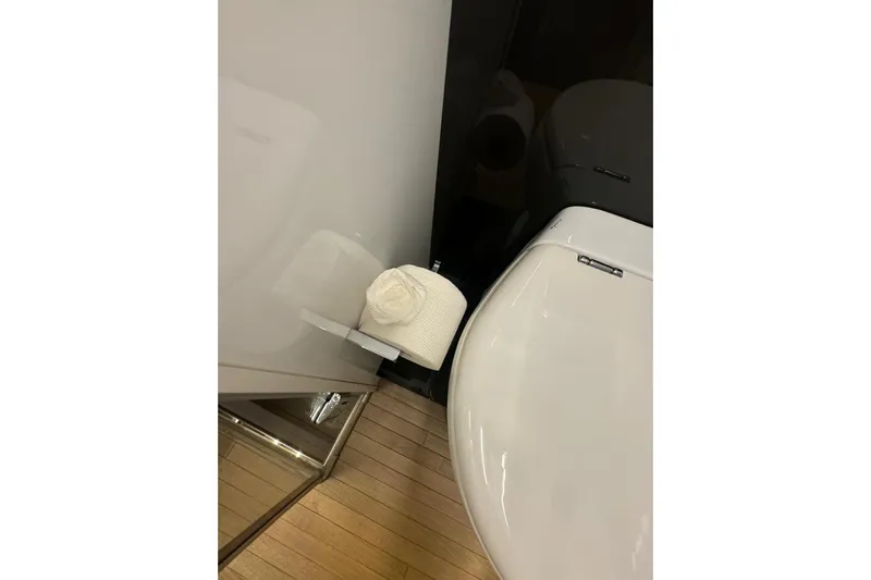  Yacht Photos Pics Luxury yacht Pershing 70 bathroom with modern toilet and wooden flooring, 2015 model.