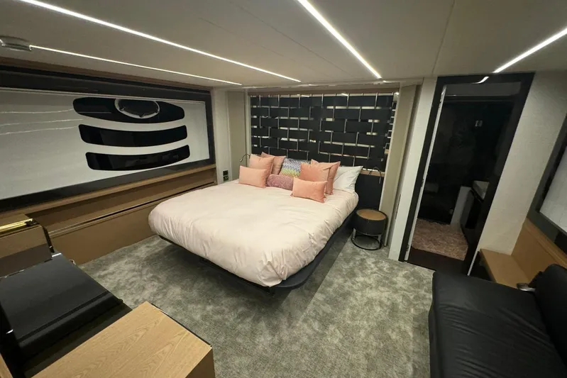  Yacht Photos Pics Luxurious bedroom interior of 2015 Pershing 70 yacht with modern design and cozy ambiance.