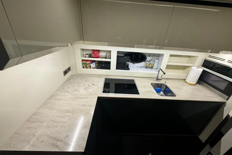  Yacht Photos Pics Modern kitchen in 2015 Pershing 70 yacht with sleek countertops and built-in appliances.