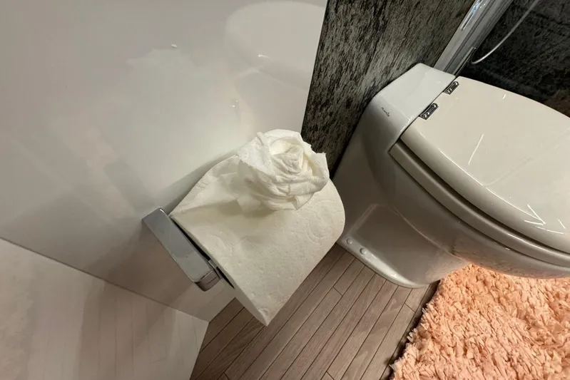  Yacht Photos Pics Luxury bathroom in 2015 Pershing 70 yacht with modern toilet and plush rug.