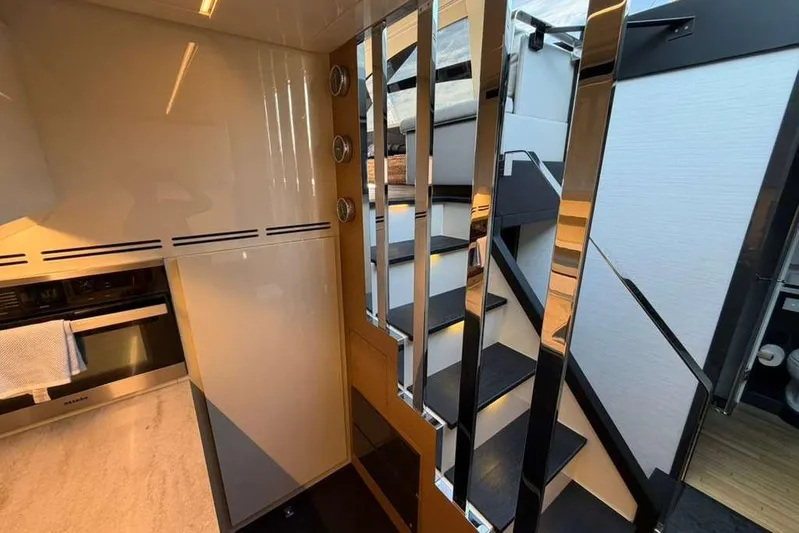  Yacht Photos Pics Luxurious interior of 2015 Pershing 70 yacht with modern staircase and sleek design.