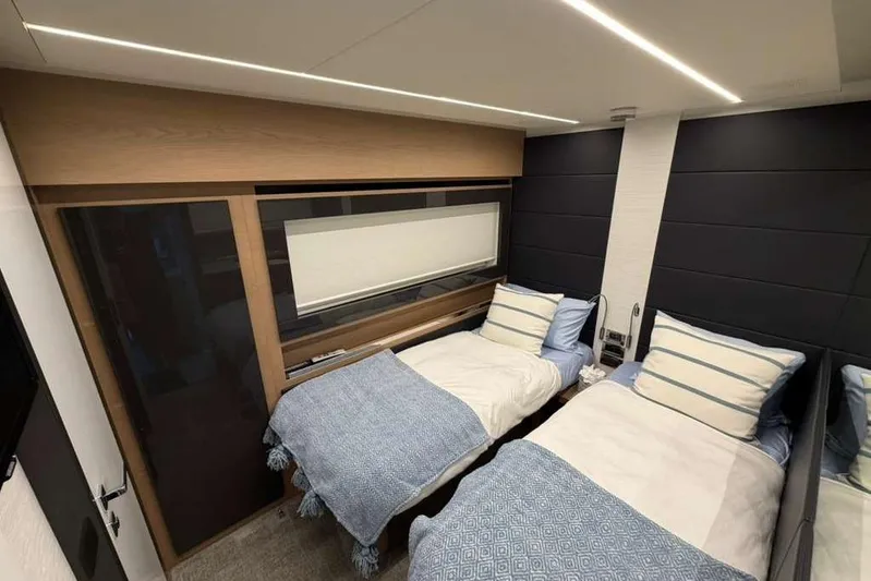  Yacht Photos Pics Luxurious twin bedroom in 2015 Pershing 70 yacht with modern decor and cozy bedding.