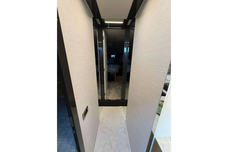  Yacht Photos Pics Narrow hallway inside a 2015 Pershing 70 yacht, featuring modern interior design.