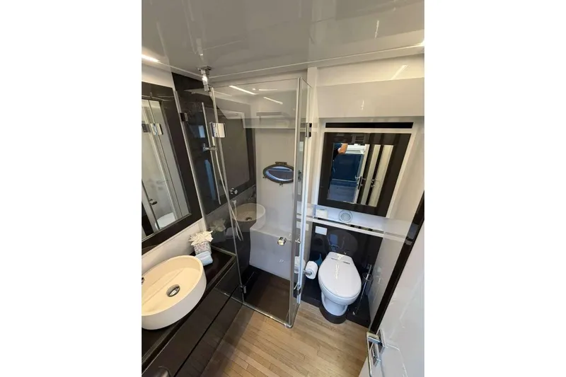  Yacht Photos Pics Luxurious bathroom in 2015 Pershing 70 yacht with modern fixtures and elegant design.