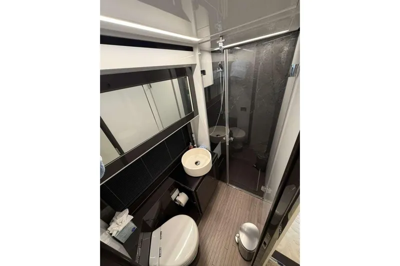  Yacht Photos Pics Luxurious bathroom interior of 2015 Pershing 70 yacht with modern fixtures and sleek design.