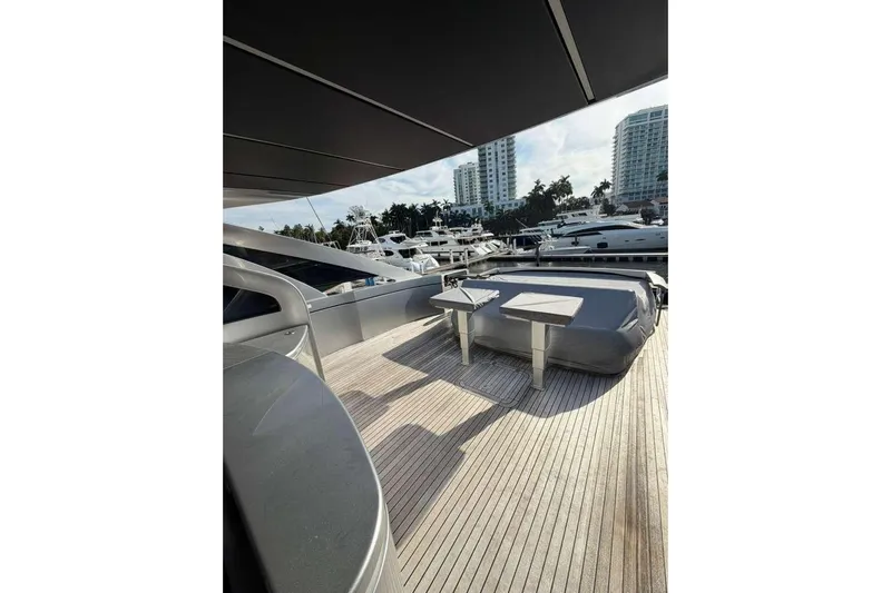  Yacht Photos Pics Luxurious 2015 Pershing 70 yacht deck with modern seating, docked in a marina.