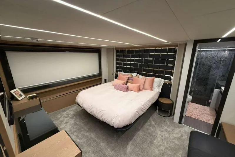  Yacht Photos Pics Luxurious bedroom interior of 2015 Pershing 70 yacht with modern decor and ensuite bathroom.