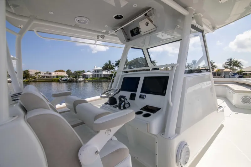 Kat Man Du Yacht Photos Pics 2017 Yellowfin 39 Center Console boat interior with helm station and waterfront view.