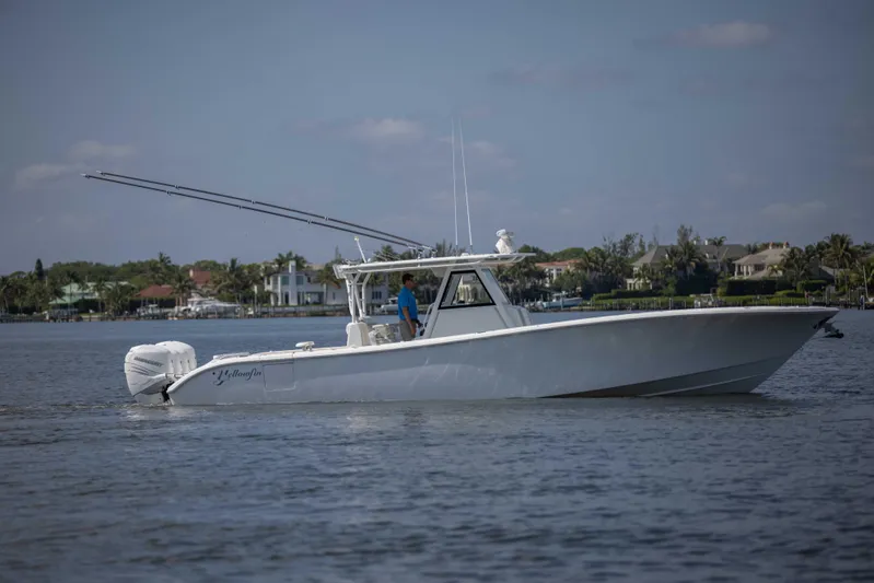 Kat Man Du Yacht Photos Pics 2017 Yellowfin 39 Center Console boat cruising on a calm waterway.