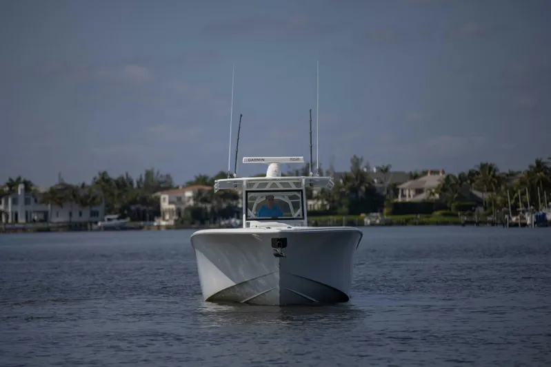 Kat Man Du Yacht Photos Pics 2017 Yellowfin 39 Center Console boat on calm water with waterfront homes in the background.