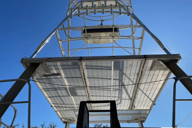 Asi Tender Yacht Photos Pics Metal structure of a 1987 Commercial Buoy Tender against a clear blue sky.