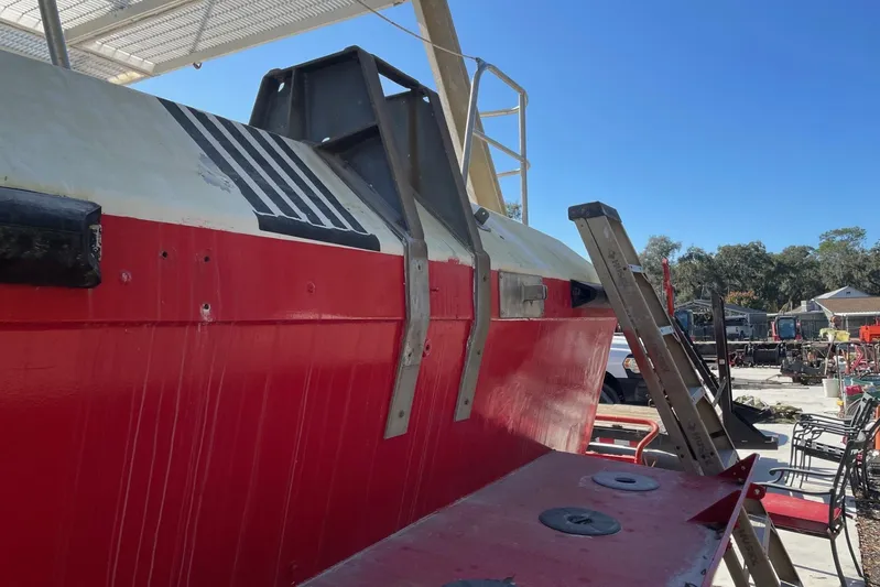 Asi Tender Yacht Photos Pics Red and white 1987 commercial buoy tender with ladder, outdoor setting.