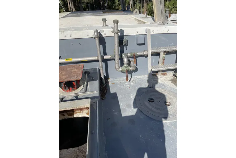 Asi Tender Yacht Photos Pics 1987 Commercial Buoy Tender deck with pipes and shadow in sunlight.