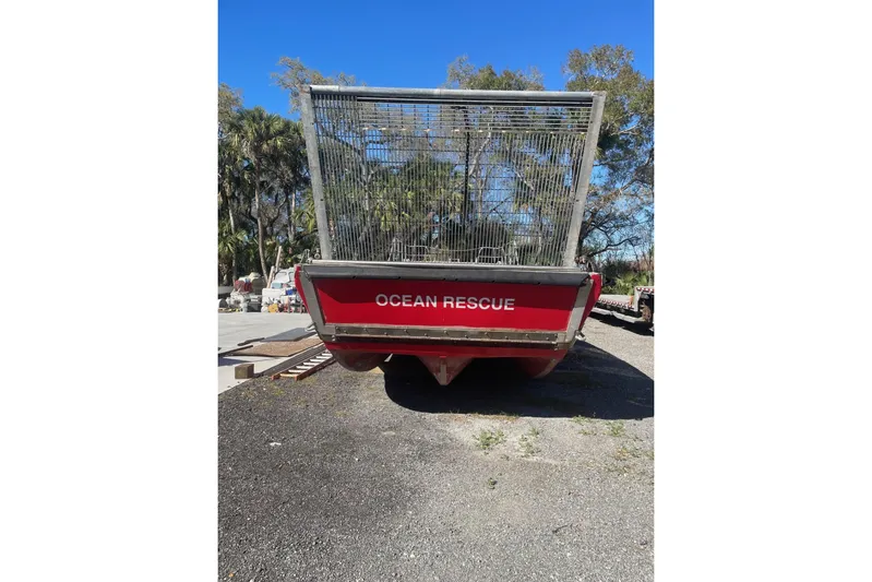 Asi Tender Yacht Photos Pics Red 1987 Commercial Buoy Tender labeled "Ocean Rescue" on land with trees in background.