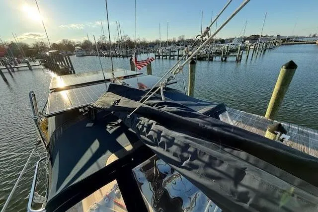 Windfall Yacht Photos Pics Sailboat docked at marina, Caliber 40LRC 1999, with American flag and sunny sky.