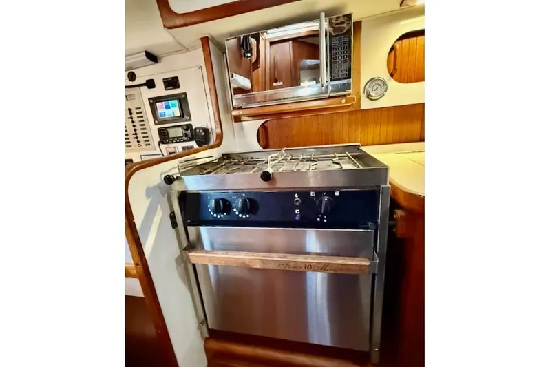 Windfall Yacht Photos Pics 1999 Caliber 40LRC yacht kitchen with stove, microwave, and control panel.