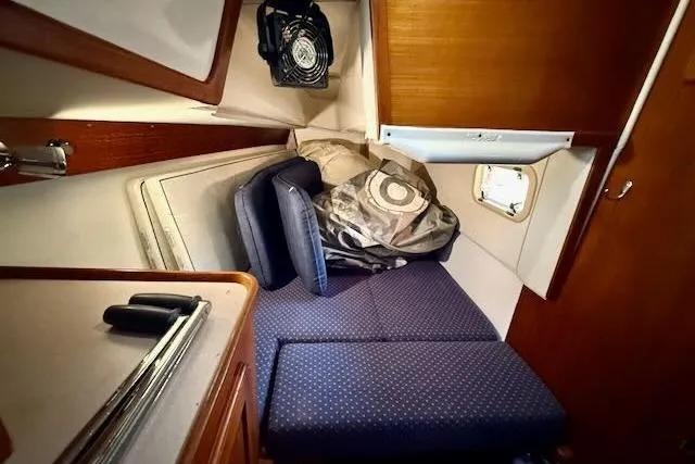 Windfall Yacht Photos Pics 1999 Caliber 40LRC cabin interior with cushions and storage space.