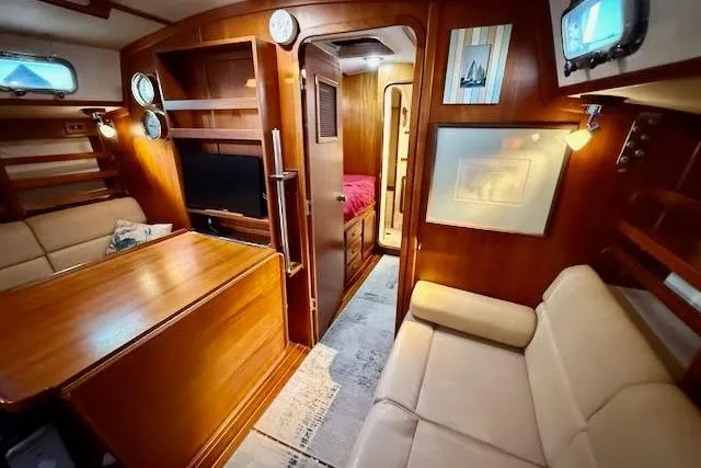 Windfall Yacht Photos Pics Luxurious 1999 Caliber 40LRC yacht interior with wood finish and cozy seating area.
