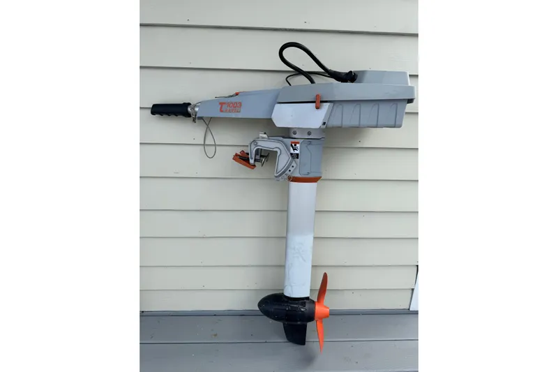 Windfall Yacht Photos Pics 1999 Caliber 40LRC outboard motor mounted on a wall, featuring orange propeller.