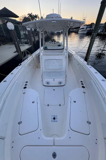  Yacht Photos Pics 2013 Edgewater 318CC boat docked at sunset, showcasing spacious deck and sleek design.